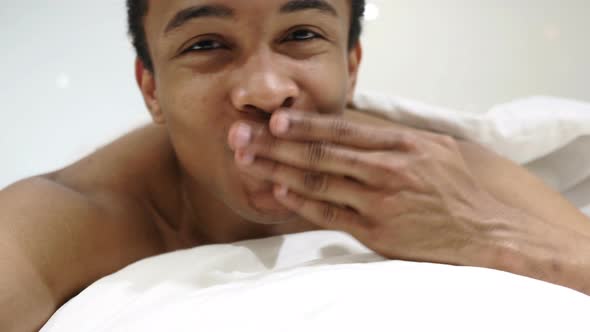 Flying Kiss by Hands, African Man Lying in Bed