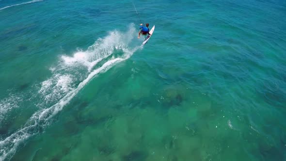 Aerial view of a man kitesurfing in Hawaii