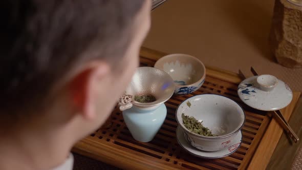 Tea Master Pours Hot Water From Kettle to Gaiwan