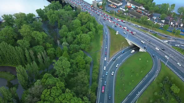 Top View of a Traffic Intersection That Turns Into a Bridge Over the River After the Rain