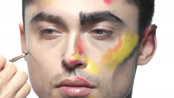 Man Having Face Makeup Applied