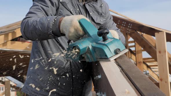 Planing a Tree with an Electric Planer.