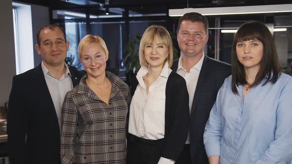 Group of Specialists Looking at Camera and Making Smiling Face