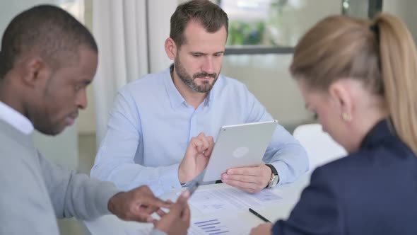 Business People Working on Tablet and Smartphone in Office