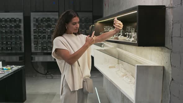 Girl Taking Picture of Earrings in Store