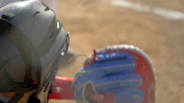 Boy plays catcher in a little league baseball game.