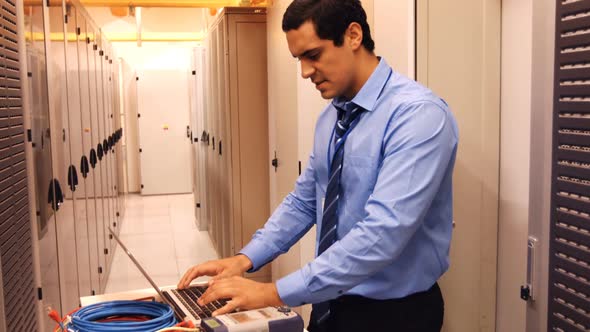 Stressed technician using laptop