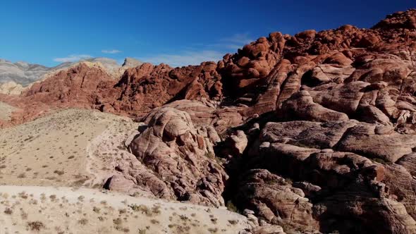 Bird's eye view of red sandstone mountains from drone, Red Rock Canyon Park near Las Vegas, Nevada