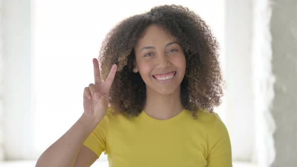 African Woman showing Victory Sign with Finger