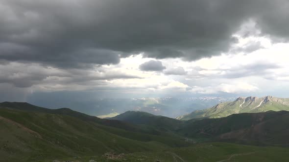 Treeless Hills and Mountains Under Cloudy Sky