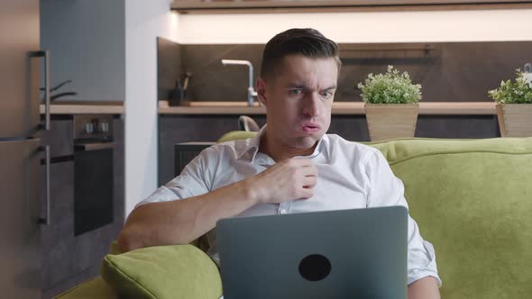 Angry Male Entrepreneur Is Experiencing Anger and Emotional Stress While Working on Laptop