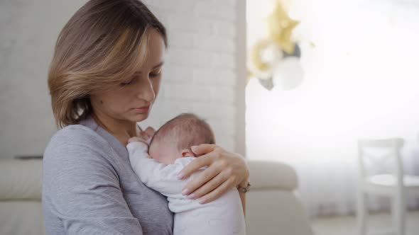 Young Mother Holding Her Newborn Child