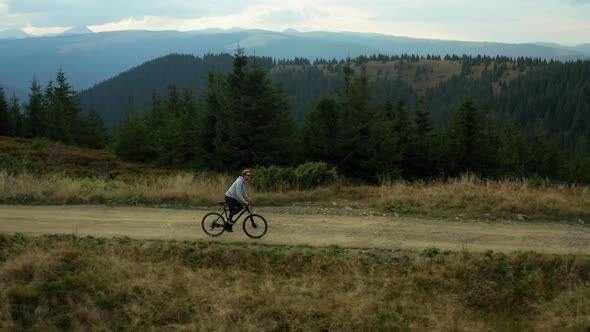 Mountain Cycling Drone View Against Stunning Spruce Forest Hills Enjoying Time