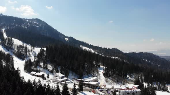 Raising up and rotating to reveal the ski slope at Poiana Brasov covered with snow