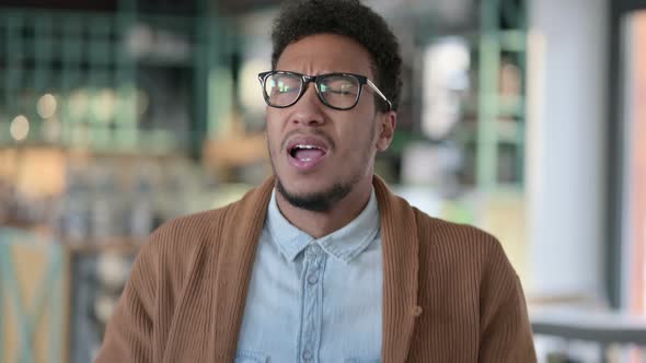 Portrait Sick Young African Man Sneezing Home