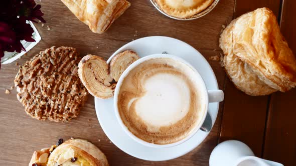 Breakfast with Croissants Pie Cookie and Cup of Coffee on Wooden Table in Cafe