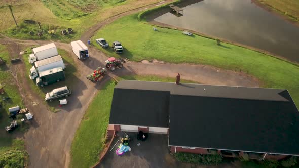 Aerial view of following tractor down country road in the rolling hills of West Virginia.