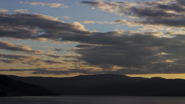 Sunset Cloudy Sky Time-lapse Over Endless Mountains And Lake Views In Paradise
