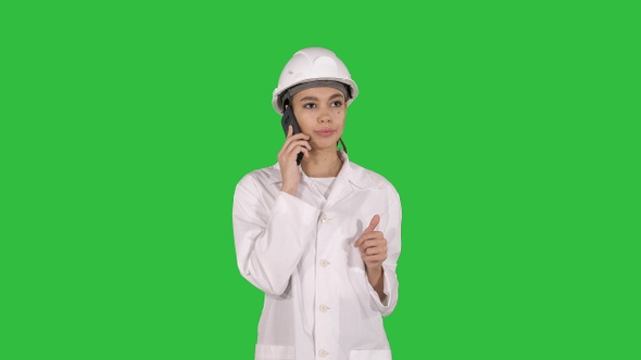 Woman engineer talking on the phone while walking