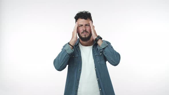 Uneasy Ill Guy Feeling Sick and Dizzy Squinting From Painful Feeling in Head Touching Temples As