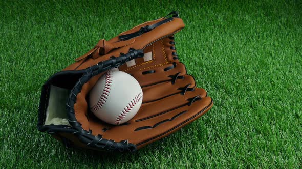 Baseball Catcher's Mitt And Ball On The Pitch