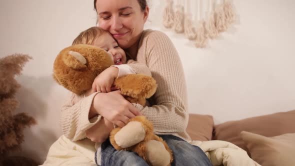 A Mom and Daughter on the Bed Play Talking Cuddles Love