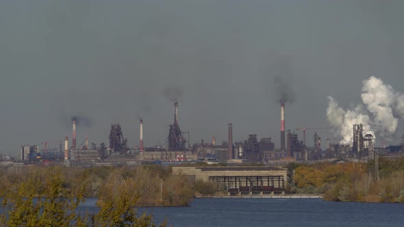 large amount of smoke and soot is emitted from the factory pipes of the metallurgical plant