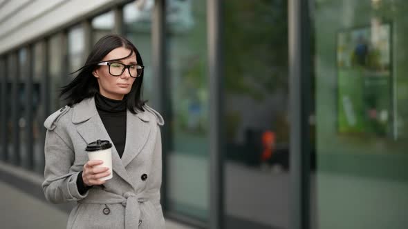 Elegant Businesswoman is Walking Alone in Morning and Drinking Coffee Go to Work