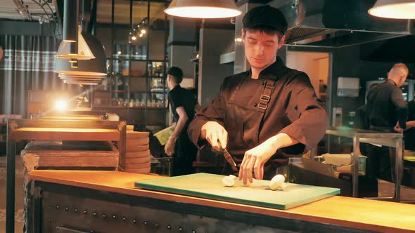 Restaurant Worker is Chopping Mushrooms