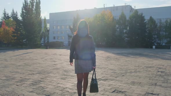 Portrait of a Woman Walking in the City in Autumn