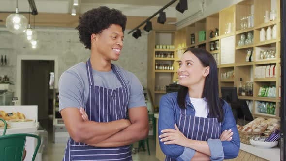 Animation of happy diverse female and male waiters at coffee shop