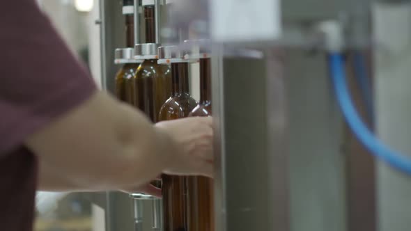 Wine Cork is Inserted Into the Bottle on a Machine