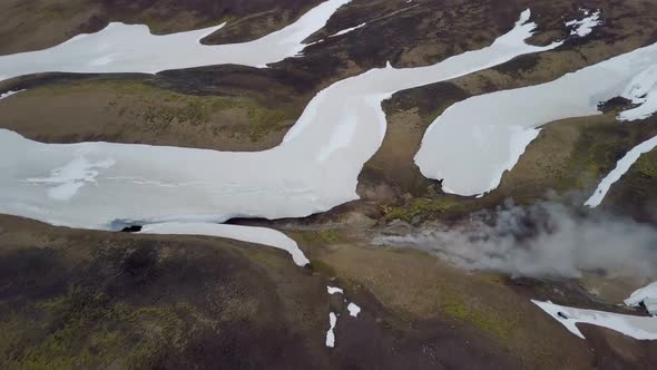 Aerial View of Dramatic Clouds over Snowy Volcanic Mountains in Iceland