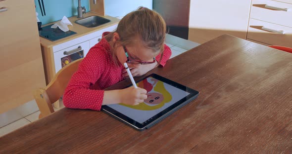 Little Girl Drawing on Tablet at Home