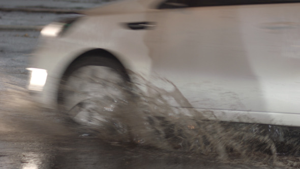 Cars And Puddles In The Rain