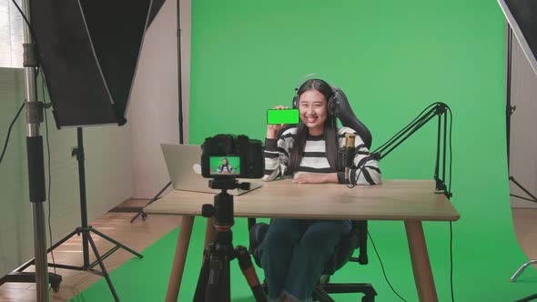 Camera Recording Asian Woman Showing Green Screen Mobile Phone On Green Screen Studio