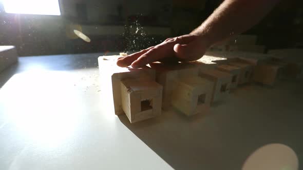 Sawdust is blown off of furniture pieces awaiting to be assembled in the process of furniture manufa