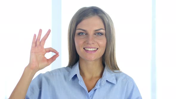 Portrait of Satisfied Young Woman Gesturing  Okay Sign