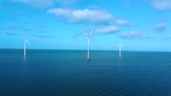 Offshore Windmill Park with Clouds and a Blue Sky Windmill Park in the Ocean Drone Aerial View with