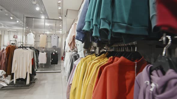 Bright Color Clothes Hanging On Racks In Store