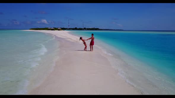 Young couple tan on marine coastline beach adventure by transparent sea with white sandy background 