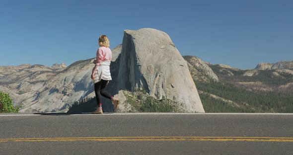 Young Girl Taking Picture Outdoors on Background of Mountain Landscape, Yosemite