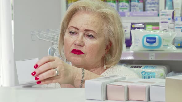 Senior Elegant Lady Shopping for Cosmetic Products at Drugstore