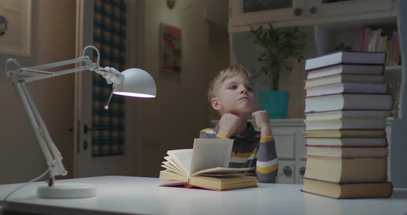 Young Child Tired of Reading Book While Stay at Home