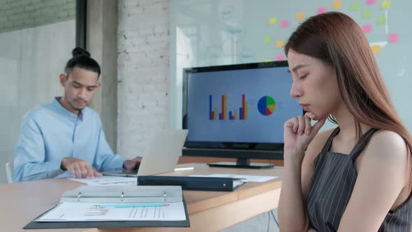 Two colleagues brainstorm and meeting business projects in an office.