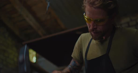 Portrait of Handsome Professional Blacksmith During Work in Forge Traditional Craft  Prores