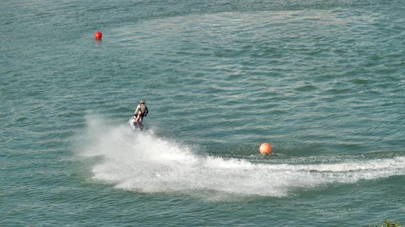 Jetski expert on a difficult course attacks the turns with speed - slow motion