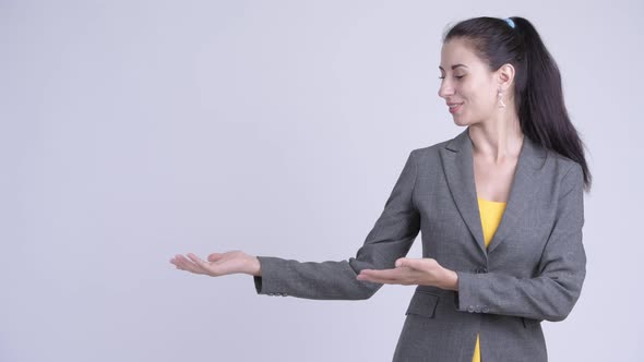 Happy Young Beautiful Businesswoman Showing Something