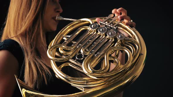 Young Beautiful Plays the French Horn