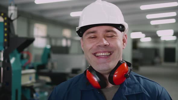 Smiling Male Factory Worker Looking at the Camera